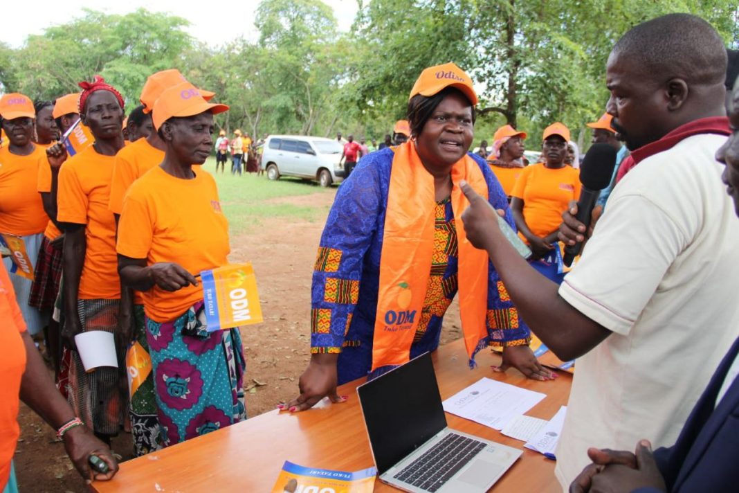 ODM to election officials verifies details of the party national chairperson Gladys Wanga before participating in the grassroots polls at Alara Korayo primary school in Kochia,Rangwe constituency on November 27,2024