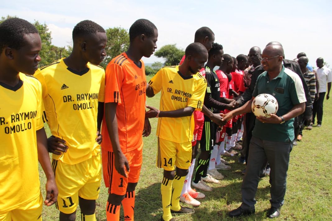 PS Omolo challenges youths to exploit sports talent for economic empowerment interior PS Raymond Omollo representative Michael Odari greets players at Wachara Karungu in Nyatike, Migori county